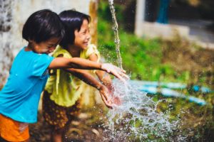Vital RX - young children playing in water