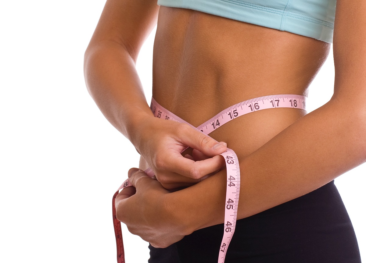 woman measuring fat loss