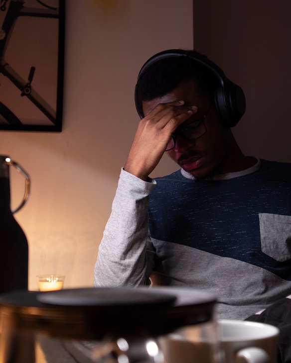 man in headphones stressing